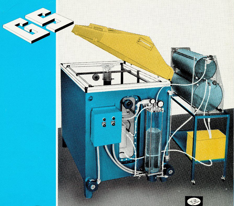 Early GS salt spray corrosion test chamber with external solution reservoirs and pneumatic controls used for ASTM B117 corrosion testing.