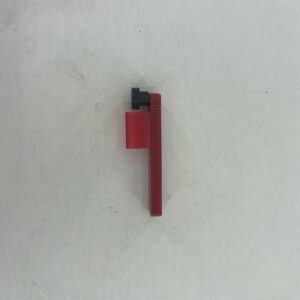 Small red plastic piece with black knob