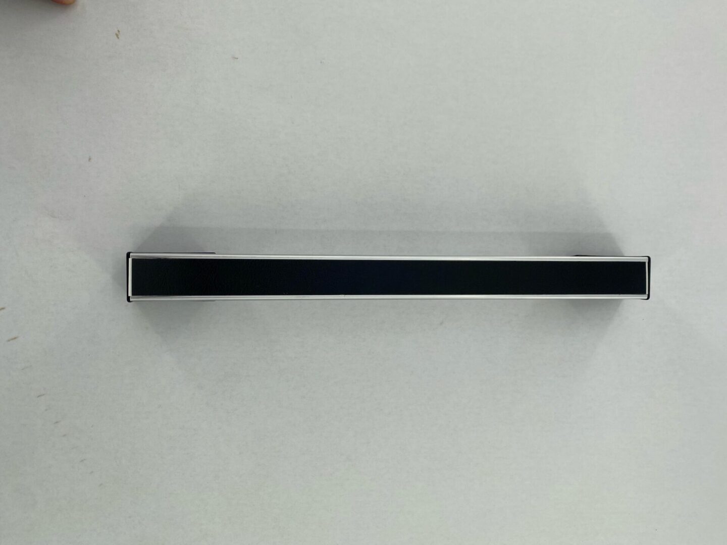 A black handle on a white door