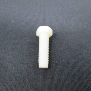 White plastic hex head bolt on black fabric