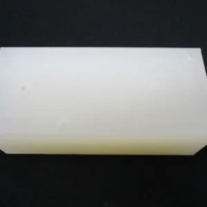 White nylon plastic block on black backdrop