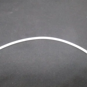 Curved white plastic trim strip on fabric