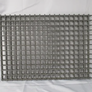 Gray square metal grating on white backdrop