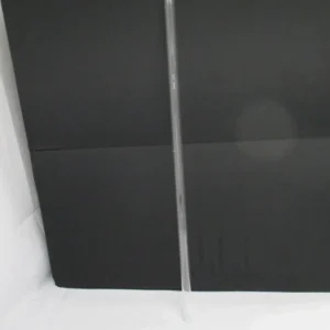 Long clear plastic tube against black backdrop