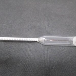 Glass hydrometer with scale on black fabric