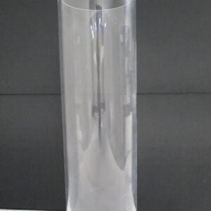 Clear acrylic cylindrical tube on backdrop