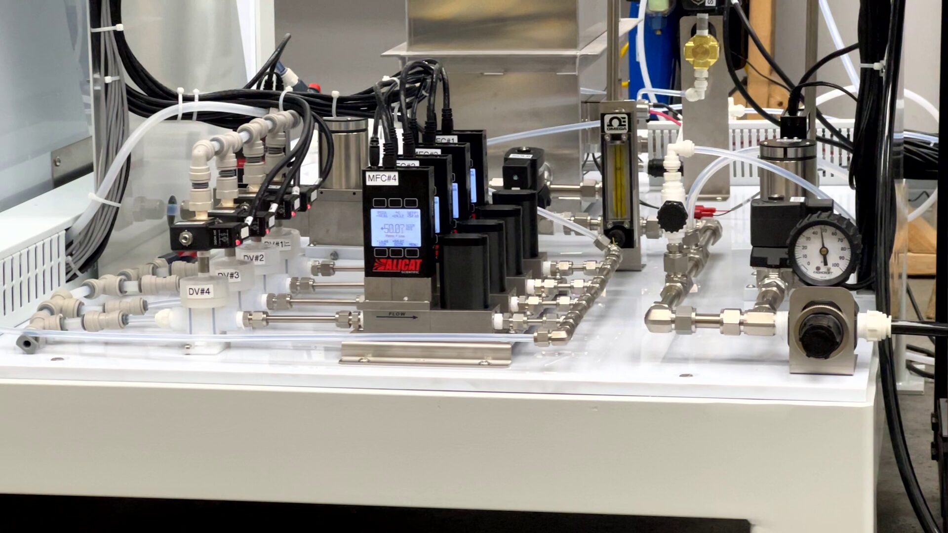 Flow controllers and instrumentation used to manage gas streams and dilution airflow for mixed flowing gas corrosion testing.