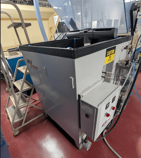 Open salt fog chamber inside an environmental testing laboratory with cyclic corrosion testing equipment.