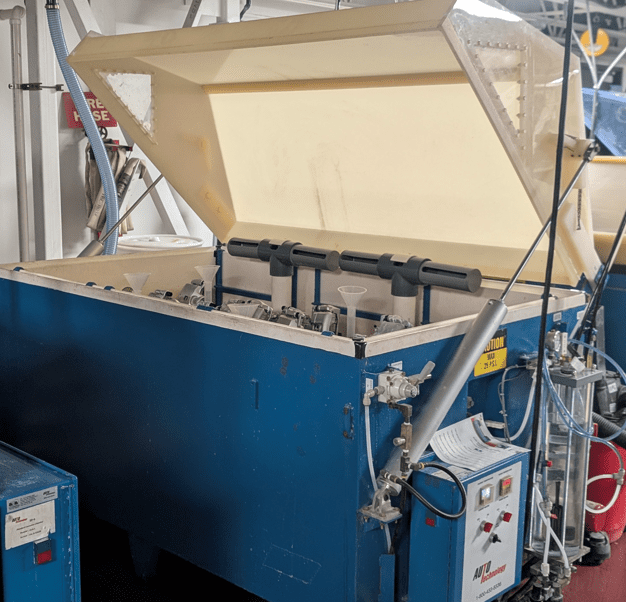 Blue industrial machine with open lid