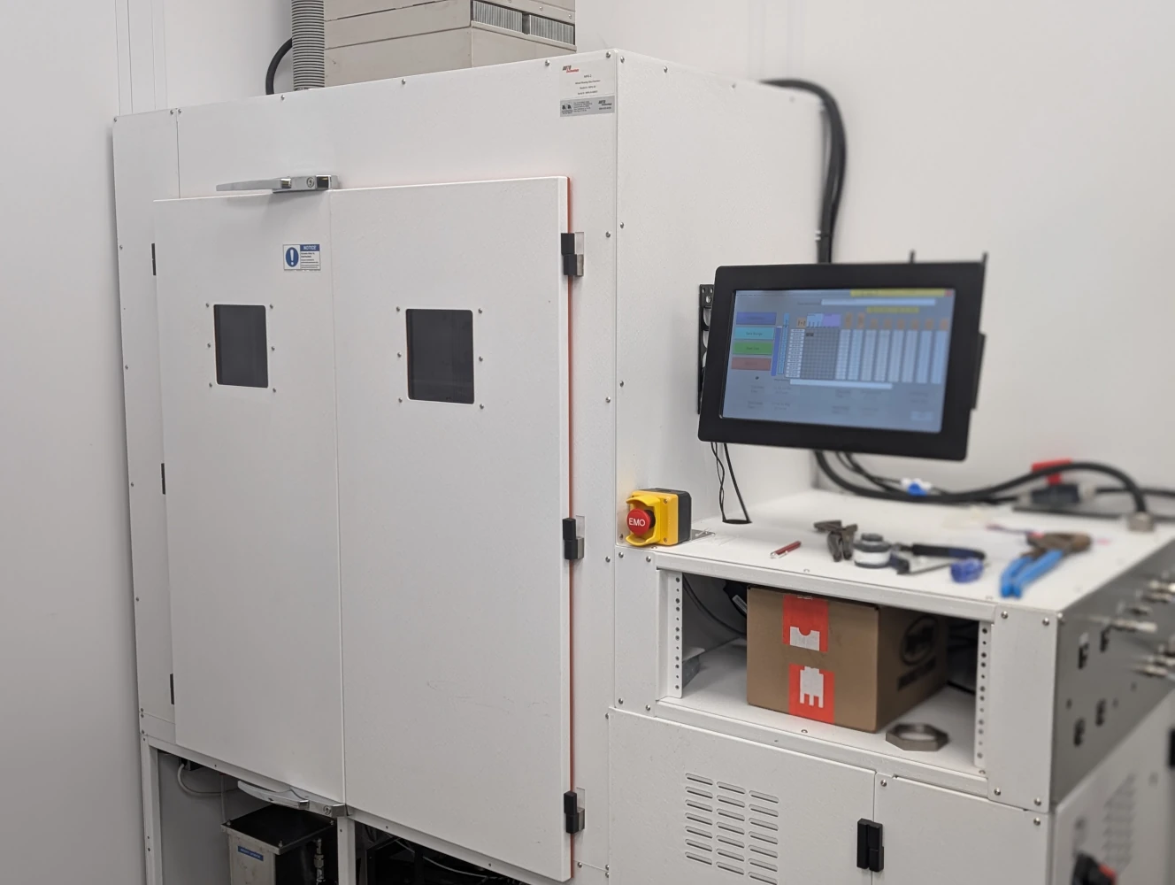 Custom 10 cubic foot MFG chamber with dual-door access and integrated control station for mixed flowing gas corrosion testing.